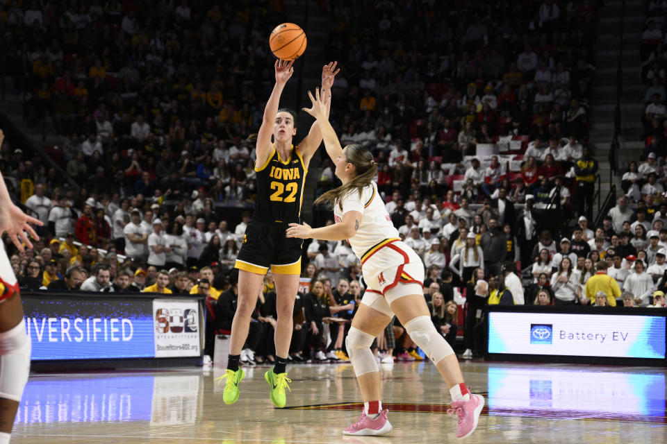 Iowa guard Caitlin Clark (22) shoots against Maryland guard Faith Masonius, right, during the first half of an NCAA college basketball game, Saturday, Feb. 3, 2024, in College Park, Md. (AP Photo/Nick Wass)