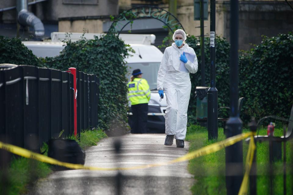 Police and forensic officers at Rawnsley Park near to the scene in the St Philips area of Bristol where a 16-year-old boy has died after being stabbed on Wednesday evening (PA)