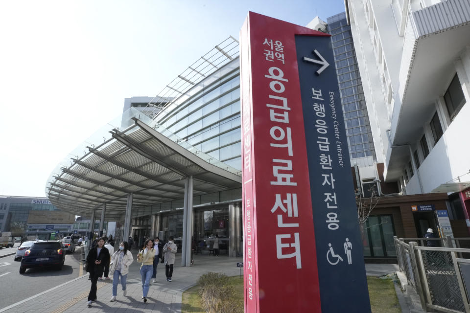 People leave Seoul National University Hospital in Seoul, South Korea, Monday, April 1, 2024. South Korea's President Yoon Suk Yeol vowed Monday not to back down in the face of vehement protests by doctors seeking to derail his plan to drastically increase medical school admissions, as he called their walkouts "an illegal collective action" that poses "a grave threat to our society." (AP Photo/Ahn Young-joon)