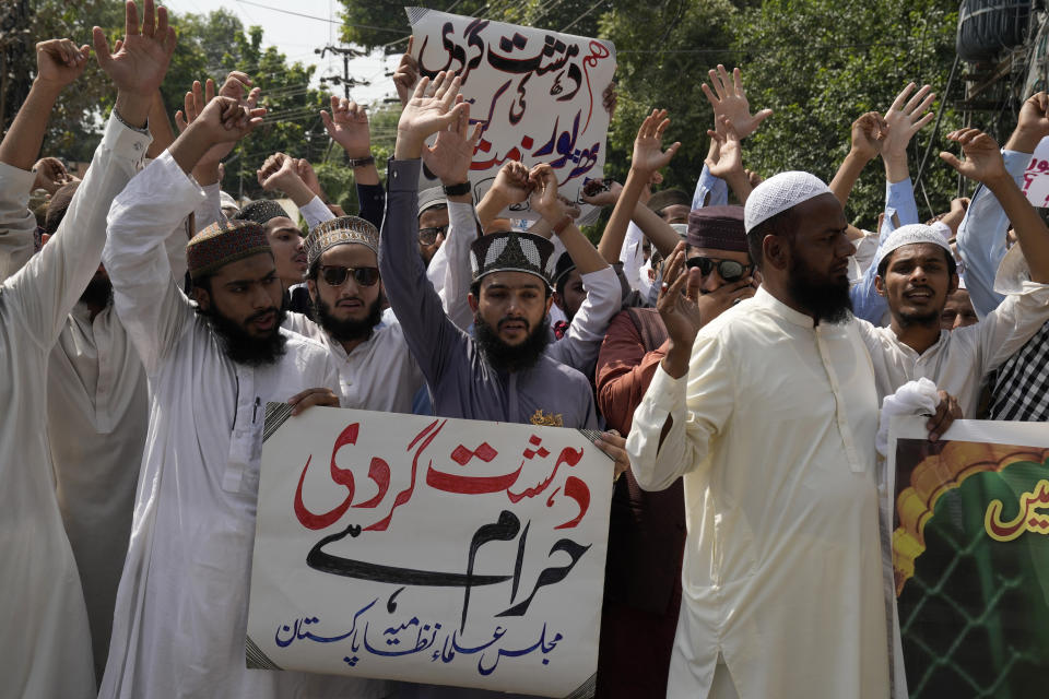 Supporters of a religious group hold a demonstration to condemn Friday's deadliest bombing in Lahore, Pakistan, Saturday, Sept. 30, 2023. A suspected suicide bomber blew himself up among a crowd of people celebrating the Prophet Muhammad's birthday in southwestern Pakistan on Friday, killing more then 50 people and wounding dozens others, authorities said, in one of the country's deadliest attacks targeting civilians in months. The placards read "we condemn terrorism and terrorism is forbidden." (AP Photo/K.M. Chaudary)