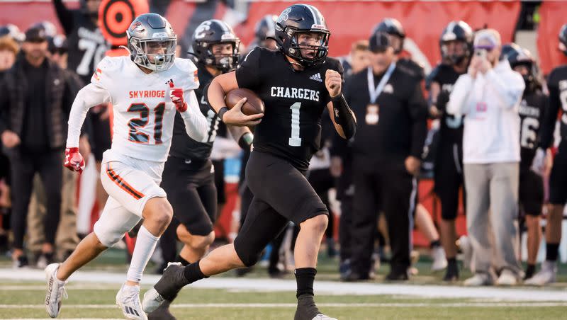 Corner Canyon’s Isaac Wilson runs away from Skyridge defense to score a touchdown in the 6A high school football championship at Rice-Eccles Stadium in Salt Lake City on Friday, Nov. 17, 2023.