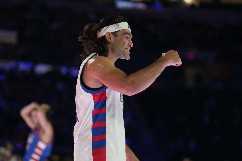 NFL wide receiver Puka Nacua celebrates during the second half of the NBA basketball All-Star Celebrity Game, Friday, Feb. 16, 2024, in Indianapolis. (AP Photo/Darron Cummings)