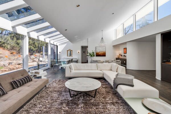 Large clerestory windows span across the main living room, complete with sliding glass doors that open up to the backyard.