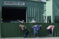 This image released by Focus Features shows Evan Rachel Wood, foreground from left, Debra Winger and Richard Jenkins in a scene from "Kajillionaire." (Matt Kennedy/Focus Features via AP)