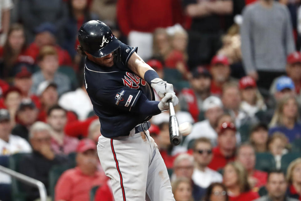 Atlanta Braves' Dansby Swanson hits an RBI double during the ninth inning in Game 3 of the baseball team's National League Division Series against the St. Louis Cardinals on Sunday, Oct. 6, 2019, in St. Louis. (AP Photo/Jeff Roberson)
