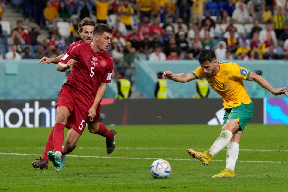 Australia's Mathew Leckie scores his side's first goal during the World Cup group D football match between Australia and Denmark, at the Al Janoub Stadium in Al Wakrah, Qatar, Wednesday, Nov. 30, 2022. (AP Photo/Thanassis Stavrakis)