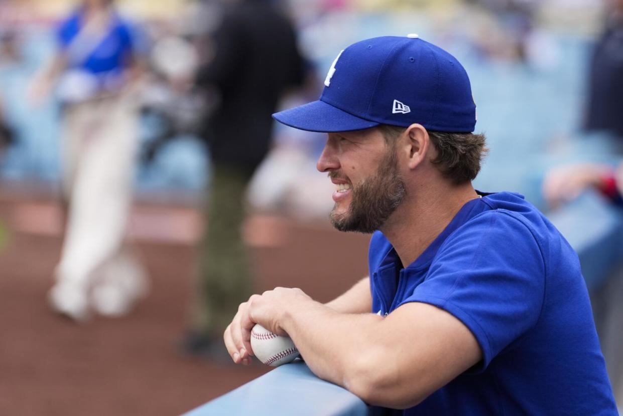 Dodgers pitcher Clayton Kershaw stands in the dugout before a game between the Dodgers and the Colorado Rockies on June 2.