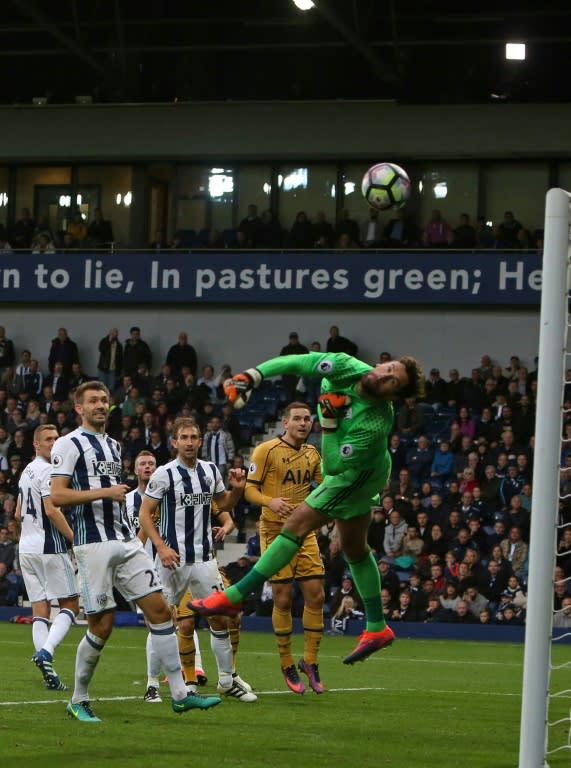 West Bromwich Albion's goalkeeper Ben Foster (R) makes a save from a late freekick during their English Premier League football match against Tottenham Hotspur, at The Hawthorns stadium in West Bromwich, on October 15, 2016 The game finished 1-1