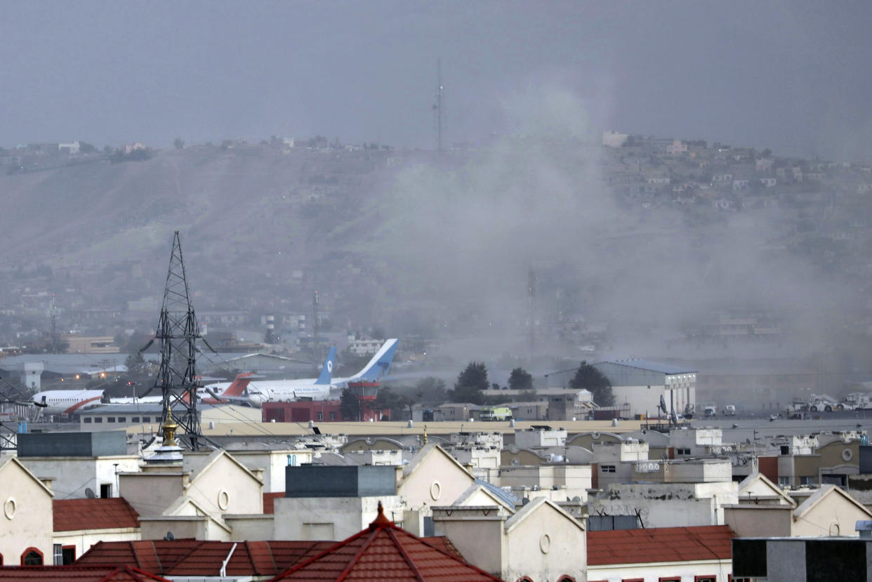 FILE - Smoke rises from a deadly explosion outside the airport in Kabul, Afghanistan, Thursday, Aug. 26, 2021. Two suicide bombers and gunmen have targeted crowds massing near the Kabul airport, in the waning days of a massive airlift that has drawn thousands of people seeking to flee the Taliban takeover of Afghanistan. The Taliban have killed the senior Islamic State group leader behind the August 2021 bombing outside the Kabul airport that killed 13 service members and about 170 Afghans. That is according to the father of a Marine killed in the attack who was briefed on April 25, 2023, by military officials. (AP Photo/Wali Sabawoon, File)