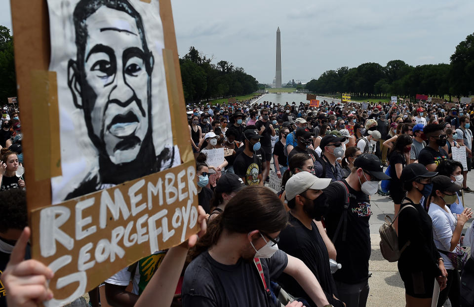Demonstrators hold placards at the Lincoln Memorial during a peaceful protest against police brutality and the death of George Floyd, on June 6, 2020 in Washington, DC. - Demonstrations are being held across the US following the death of George Floyd on May 25, 2020, while being arrested in Minneapolis, Minnesota. (Photo by Olivier DOULIERY / AFP) (Photo by OLIVIER DOULIERY/AFP via Getty Images)
