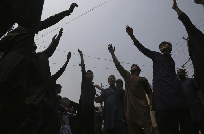 Shiite Muslims beat their chest in a ritual during a Muharram procession, in Peshawar, Pakistan, Monday, Aug. 8, 2022. Muharram, the first month of the Islamic calendar, is a month of mourning for Shiites in remembrance of the death of Hussein, the grandson of the Prophet Muhammad, at the Battle of Karbala in present-day Iraq in the 7th century. (AP Photo/Muhammad Sajjad)