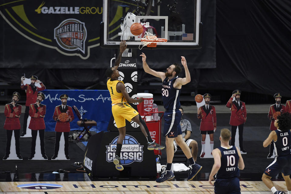 San Francisco's Jamaree Bouyea goes up for a basket against Virginia's Jay Huff, right, in the second half of an NCAA college basketball game, Friday, Nov. 27, 2020, in Uncasville, Conn. (AP Photo/Jessica Hill)