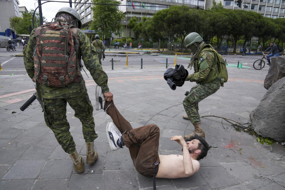 Soldiers detain a demonstrator during protests against the government of President Guillermo Lasso and rising fuel prices in Quito, Ecuador, Tuesday, June 21, 2022. Ecuador's defense minister warned Tuesday that the country's democracy was at risk as protesters attacked the prosecutor's office and demonstrations turned increasingly violent in the capital. (AP Photo/Dolores Ochoa)