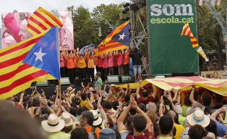 Demonstrators applaud the Gospel Gracia choir during the "Decided, Catalan school" demonstration in Barcelona, in this June 14, 2014 file photograph. For 30 years, public schools in Spain's Catalonia region have taught most subjects in Catalan, not the national Castilian Spanish language. REUTERS/Gustau Nacarino/Files