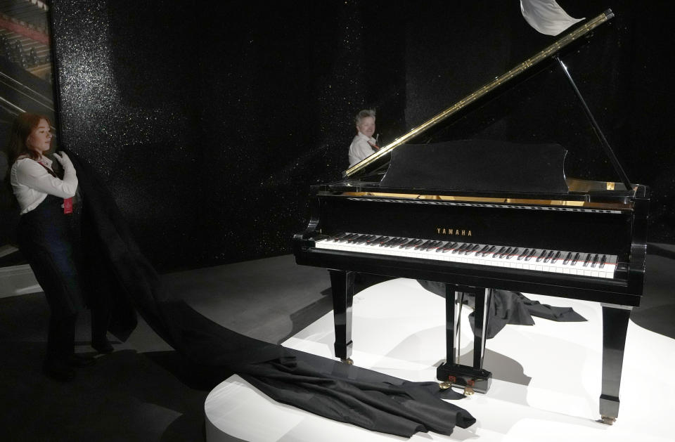 Freddie Mercury's Yamaha Grand Piano, estimated at 2-3 million pounds, on display at Sotheby's auction rooms in London, Thursday, Aug. 3, 2023. More than 1,000 of Freddie Mercury's personal items, including his flamboyant stage costumes, handwritten drafts of “Bohemian Rhapsody” and the baby grand piano he used to compose Queen's greatest hits, are going on show in an exhibition at Sotheby's London ahead of their sale. (AP Photo/Kirsty Wigglesworth)