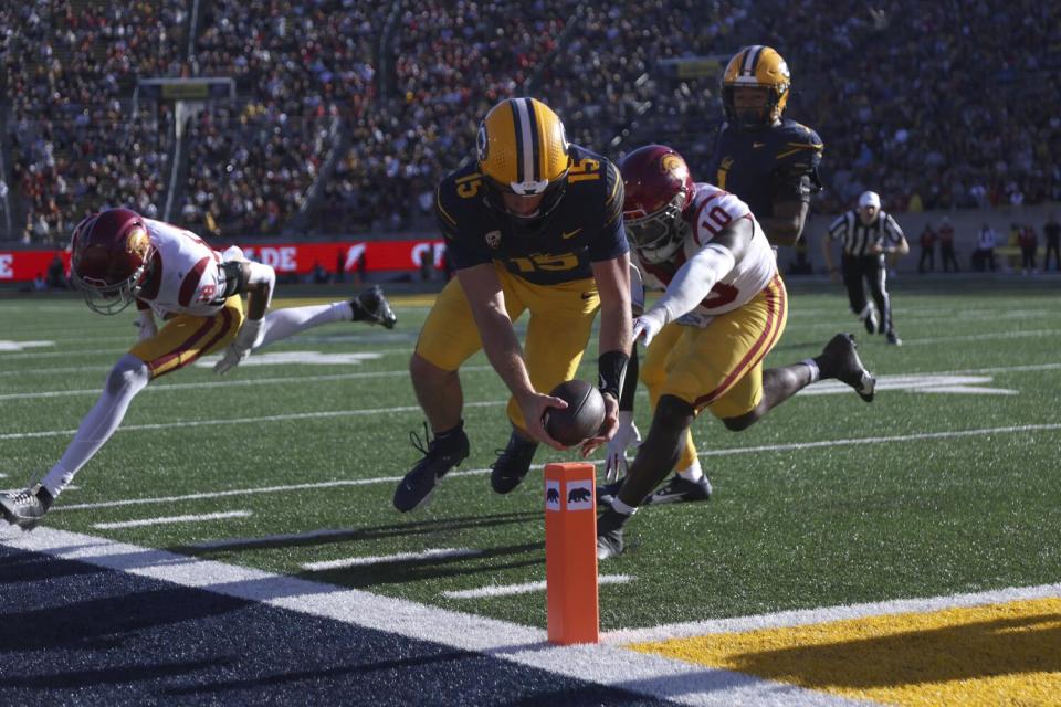 Cal quarterback Fernando Mendoza dives for a touchdown in front of USC defensive end Jamil Muhammad.