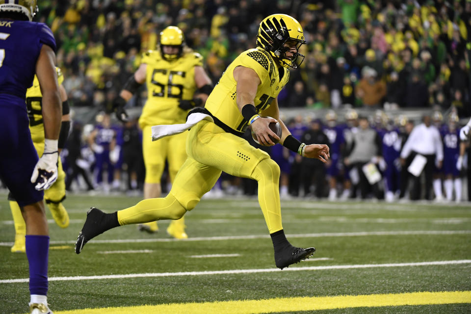 Oregon quarterback Bo Nix (10) scores against Washington during the first half of an NCAA college football game Saturday, Nov. 12, 2022, in Eugene, Ore. (AP Photo/Andy Nelson)