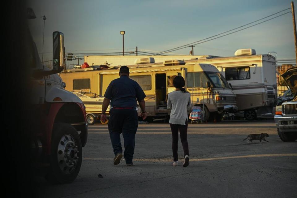 Nicole Casper walks with Iran Chima in search of her motor home at Chima’s Tow in Sacramento on Monday. “They took photo albums – sentimental things – my Bible since I was a kid, stuff that will never be replaced. It’s beyond hurtful,” Casper said. Chima told her that she can return to retrieve her belongings, but she has to retrieve everything. She wasn’t sure she could do that without a car, but she thanked him anyway.