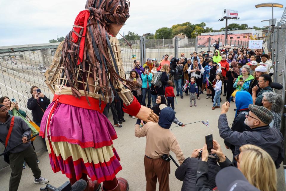 Little Amal, a 12-foot-tall puppet of a 10-year-old Syrian refugee girl, traveled to Detroit as a symbol of displaced people across the globe and walked across the Bagley Pedestrian Bridge and stopped to greet a young Muslim girl in southwest Detroit on Wednesday, Sept. 27, 2023.