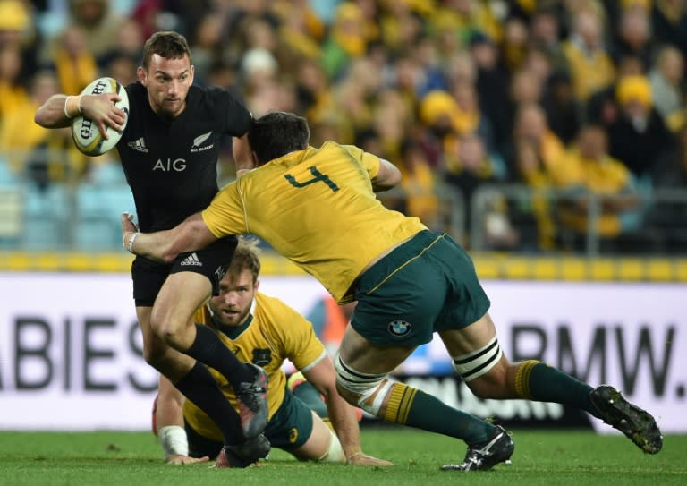 Aaron Cruden of New Zealand (L) is tackled by Kane Douglas of Australia during their Bledisloe Cup match in Sydney, on August 20, 2016