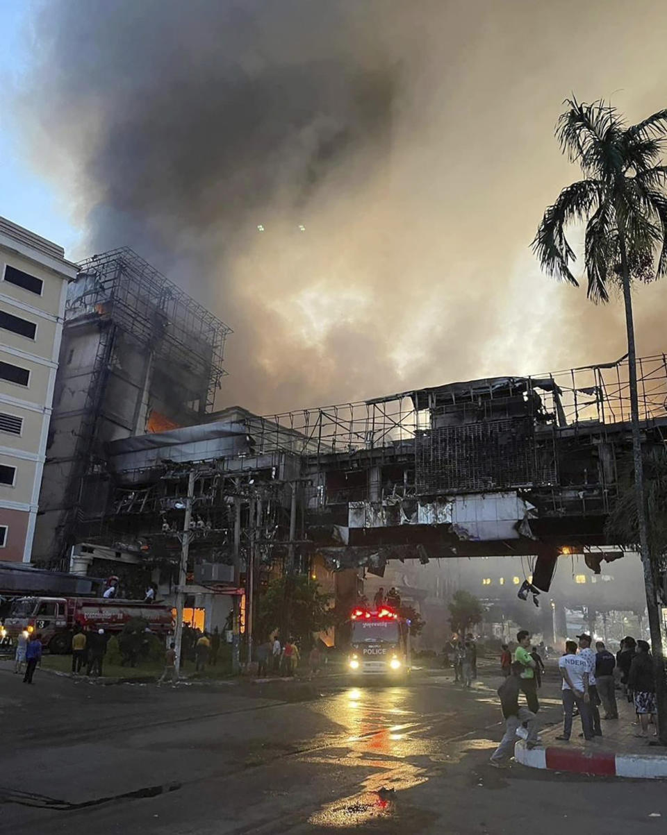 CORRECTS DATE In this photo provided by Cambodia's Fresh News, smoke rises as a fire burns through a Cambodian hotel casino near a Cambodia-Thai international border gate in Poipet, west of Phnom Penh, Cambodia, Thursday Dec. 29, 2022. A fire burning through the Grand Diamond City Casino and Hotel has killed multiple people and injured dozens of others, police said Thursday, and neighboring Thailand sent firetrucks to help fight the blaze in a bustling border region. (Fresh News/Photo via AP)