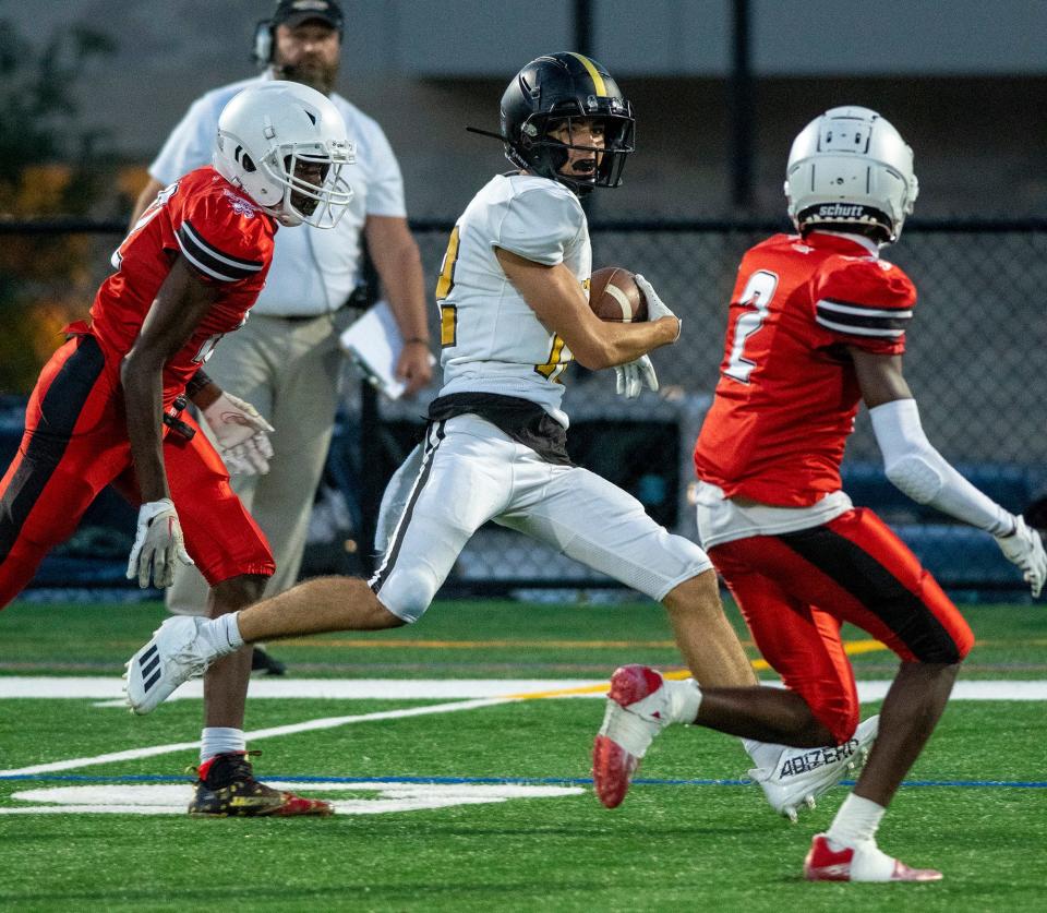 St. Paul's John Walsh Karam catches a pass and runs into two South defenders.