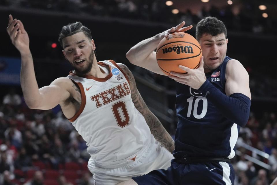 Tp10 grabs a rebound in front of Texas' Timmy Allen during the second half of a second-round college basketball game in the NCAA Tournament Saturday, March 18, 2023, in Des Moines, Iowa. (AP Photo/Morry Gash)