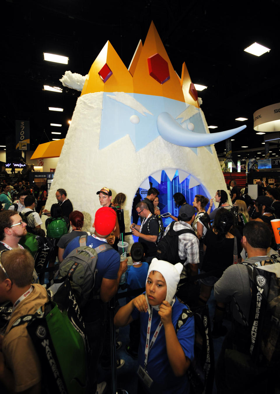 In this July 17, 2013, file photo, fans wait to walk through a huge "Adventure Time" Ice King character at the Cartoon Network booth at the 2013 Comic-Con International Convention in San Diego. Although traditional comic book characters still play a central role at conventions, television characters like Ice King have also become hugely popular. (Photo by Denis Poroy/Invision/AP, File)
