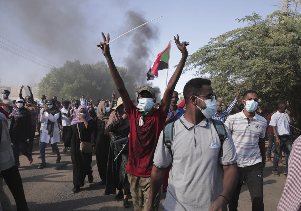 Sudanese protest against the military takeover, which upended the country’s fragile transition to democracy, in Khartoum, Sudan, Sunday, Nov. 21, 2021. Sudan’s military and civilian leaders signed a deal Sunday to reinstate Prime Minister Abdalla Hamdok, who was deposed in a coup last month. The country’s top general, Abdel Fattah Burhan, said in televised statements that Hamdok will lead an independent technocratic Cabinet until elections can be held. (AP Photo/Marwan Ali)