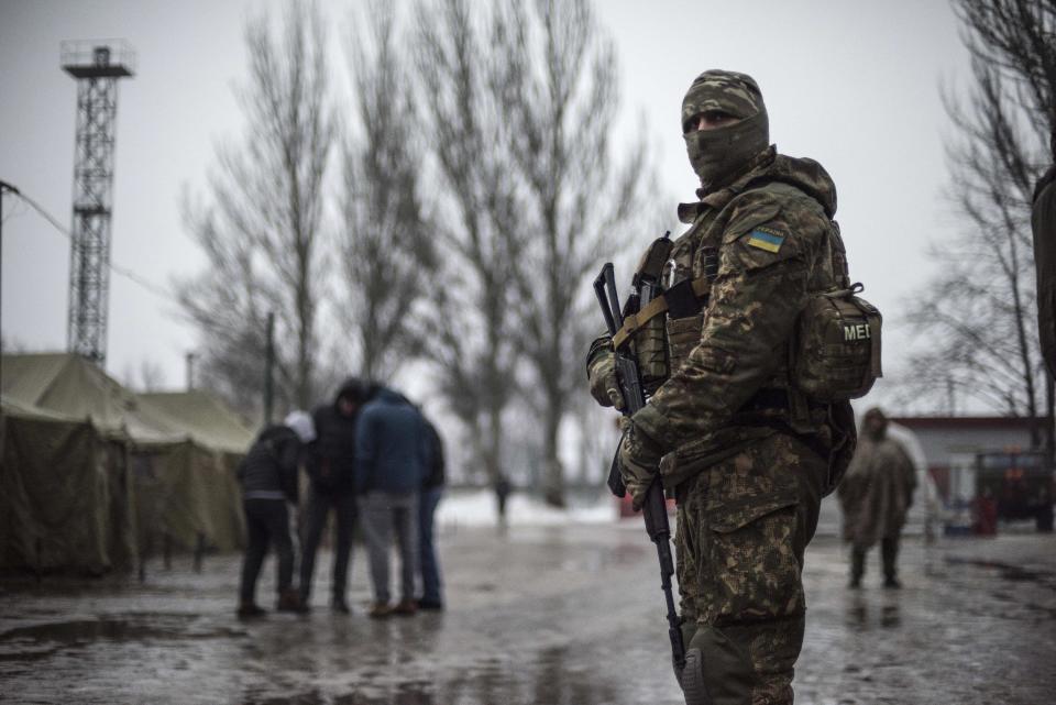 A Ukrainian serviceman patrols at the humanitarian aid center in Avdiivka, Ukraine, Saturday, Feb. 4, 2017. Fighting in eastern Ukraine sharply escalated this week. Ukraine's military said several soldiers were killed over the past day in shelling in eastern Ukraine, where fighting has escalated over the past week. (AP Photo/Evgeniy Maloletka)