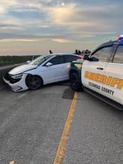 Photo of white car stopped during PIT maneuver 