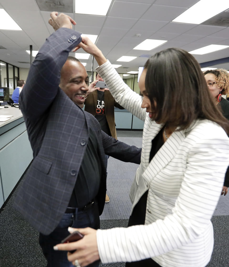 State Attorney Aramis Ayala, right, celebrates with her husband David, a former felon, after he registered to vote at the Supervisor of Elections office Tuesday, Jan. 8, 2019, in Orlando, Fla. Former felons in Florida began registering for elections on Tuesday, when an amendment that restores their voting rights went into effect. (AP Photo/John Raoux)