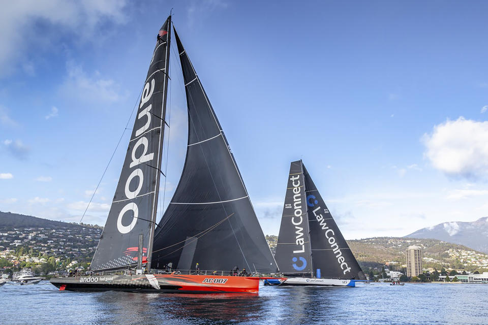 Super maxis Comanche, left, and LawConnect duel for the lead near the finish of the Sydney Hobart yacht race in Hobart, Australia, Thursday, Dec. 28, 2023. LawConnect wins the battle to finish to take line honors in the 630-nautical mile race. (Kurt Arrigo/Rolex/CYCA via AP)