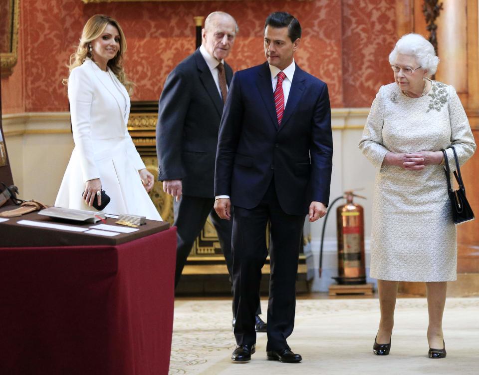 The First Lady of Mexico Angela Rivera, Prince Phillip, Mexico's President Enrique Pena Nieto and Britain's Queen Elizabeth view a display of Mexican items in the Royal Collection by at Buckingham Palace, London