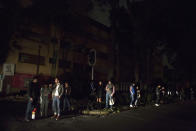 <p>People who evacuated from bars during an earthquake stand in the street in La Roma neighborhood of Mexico City, sections of which lost power, just before midnight on Thursday, Sept. 7, 2017. (AP Photo/Rebecca Blackwell) </p>