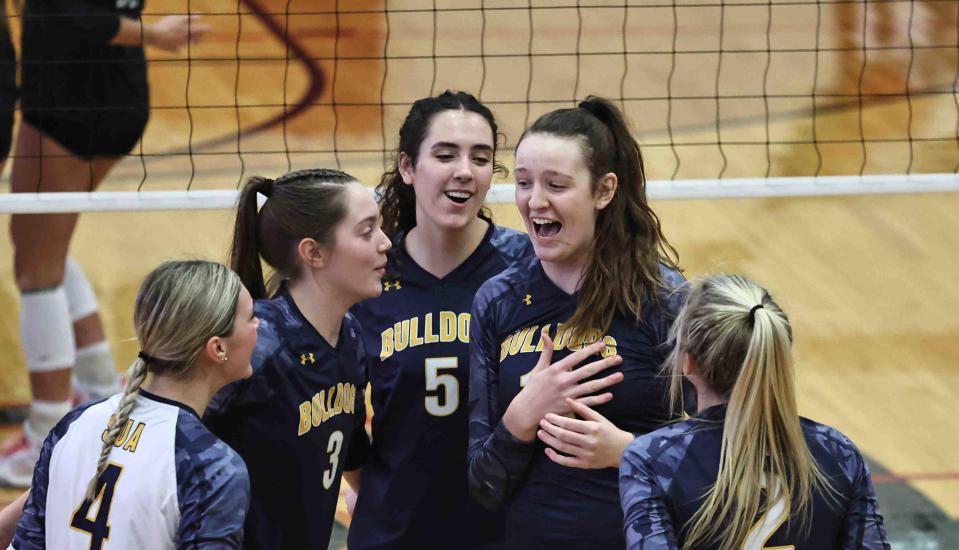 St.Ursula player Gabby Semona (11) celebrates with hear teammates Nia Jones (5), Addy Brus,(3) and Kaleigh Frietch (4) during their regional tournament volleyball game against Seton Thursday, Nov. 2, 2023.