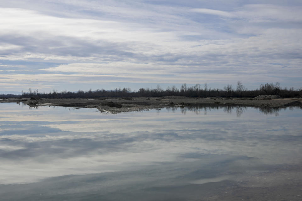 A view of the bank of the Drina River near the village of Amajlije, eastern Bosnia, Sunday, Feb. 4, 2024. In several cities along this river between Bosnia and Serbia, simple, durable gravestones now mark the final resting places of dozens of refugees and migrants who drowned in the area while trying to reach Western Europe. (AP Photo/Darko Vojinovic)