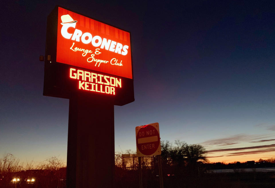 In this Sunday, Dec. 16, 2018 photo, a sign promoting an appearance by former "A Prairie Home Companion" host Garrison Keillor is displayed outside Crooners lounge in Fridley, Minn. Keillor is stepping back into the spotlight a year after Minnesota Public Radio cut ties with him over a sexual misconduct allegation. Keillor performed two sold-out shows Sunday night at Crooners, a jazz nightclub in a Minneapolis suburb near where he grew up. Fans laughed, applauded and sang along. (AP Photo/Jeff Baenen)
