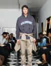 In this Friday, Sept. 13, 2019 photo provided by Bstroy, models at a show for fashion brand Bstroy wear hoodies emblazoned with the names of schools touched by mass shootings, at an apartment in the Soho neighborhood of Manhattan in New York. The hoodies have created a backlash from critics who say they glamorize violence and aim to profit from tragedy. Bstroy co-founder Dieter Grams says the hoodies are an effort to bring attention to gun violence and are not for retail sale. (Bstroy via AP)