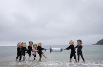 Activists wearing giant heads of the G7 leaders tussle over a giant COVID-19 vaccine syringe during an action of NGO's on Swanpool Beach in Falmouth, Cornwall, England, Friday, June 11, 2021. Leaders of the G7 begin their first of three days of meetings on Friday in Carbis Bay, in which they will discuss COVID-19, climate, foreign policy and the economy. Depicted from left to right, Japan's Prime Minister Yoshihide Suga, Italy's Prime Minister Mario Draghi, Canadian Prime Minister Justin Trudeau, German Chancellor Angela Merkel, British Prime Minister Boris Johnson, U.S. President Joe Biden and French President Emmanuel Macron. (AP Photo/Kirsty Wigglesworth)