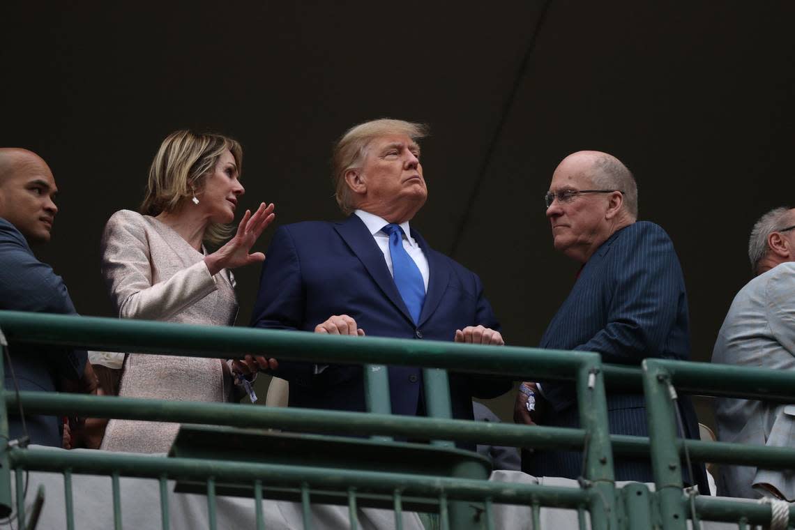 Kelly and Joe Craft stand on either side of former US President Donald Trump before the start of the 148th Kentucky Derby at Churchill Downs in Louisville, Ky., Saturday, May 7, 2022.