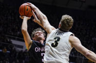 Purdue's Caleb Furst (3) blocks the shot of Omaha's Kyle Luedtke (3) during the first half of an NCAA college basketball game in West Lafayette, Ind., Friday, Nov. 26, 2021. (AP Photo/Michael Conroy)