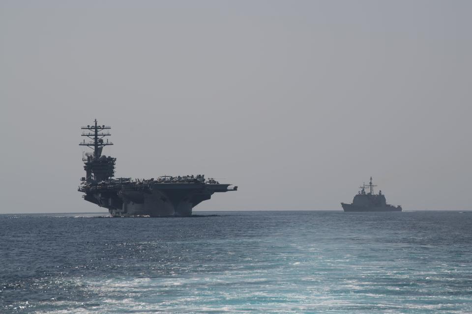 The aircraft carrier USS Nimitz, left, and the guided-missile cruiser USS Philippine Sea steam in formation during a Strait of Hormuz transit back on Sept. 18. On Friday, the Nimitz and its strike group was ordered back to the Persian Gulf.