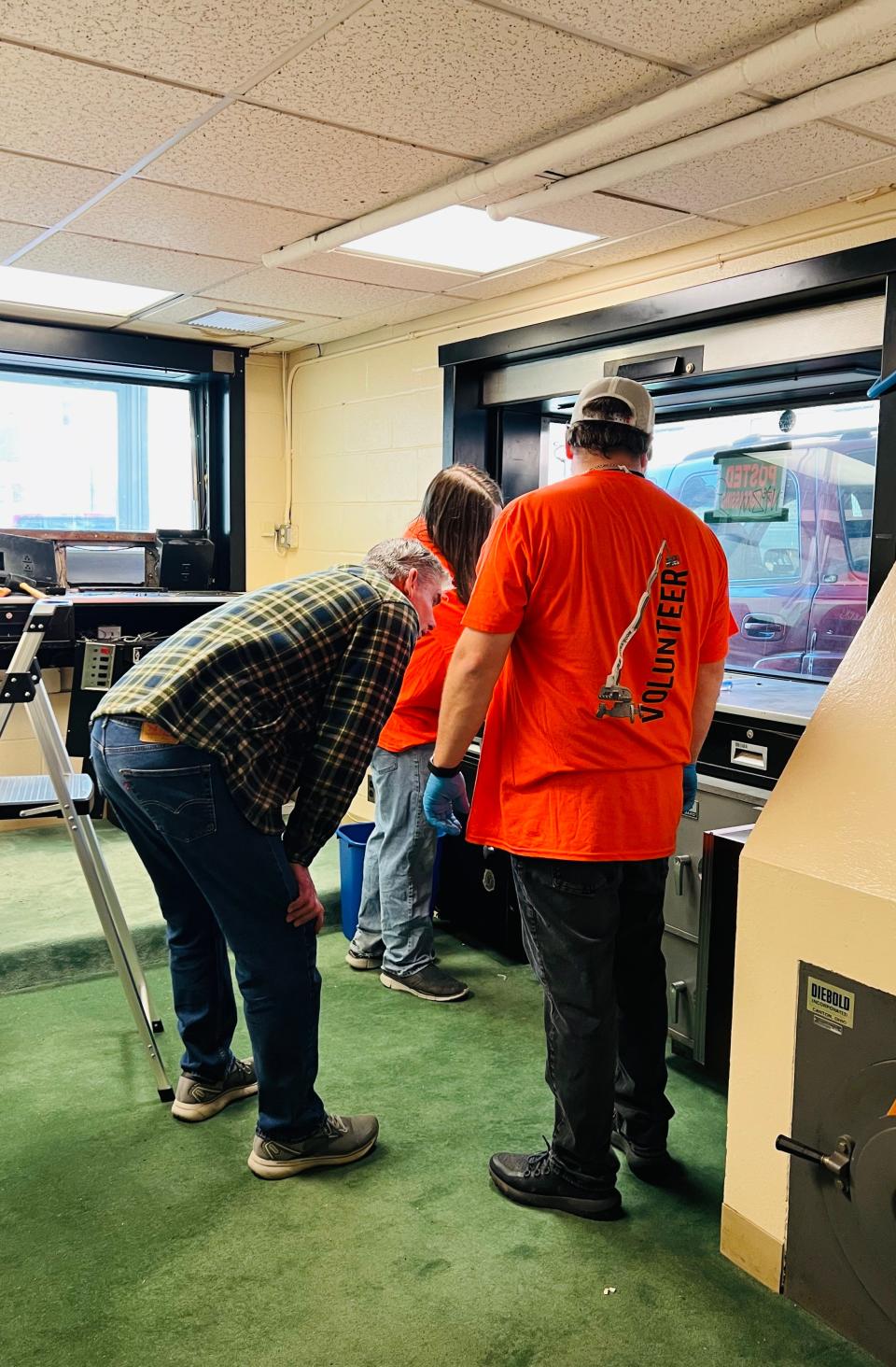 JLG Industries volunteers make repairs to a drive-through mechanism that United Way of Washington County will use to distribute hygiene items.