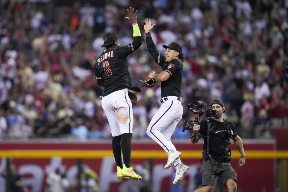 Arizona Diamondbacks center fielder Alek Thomas and shortstop Geraldo Perdomo celebrates their win against the Philadelphia Phillies in Game 4 of the baseball NL Championship Series in Phoenix, Friday, Oct. 20, 2023. (AP Photo/Ross D. Franklin)