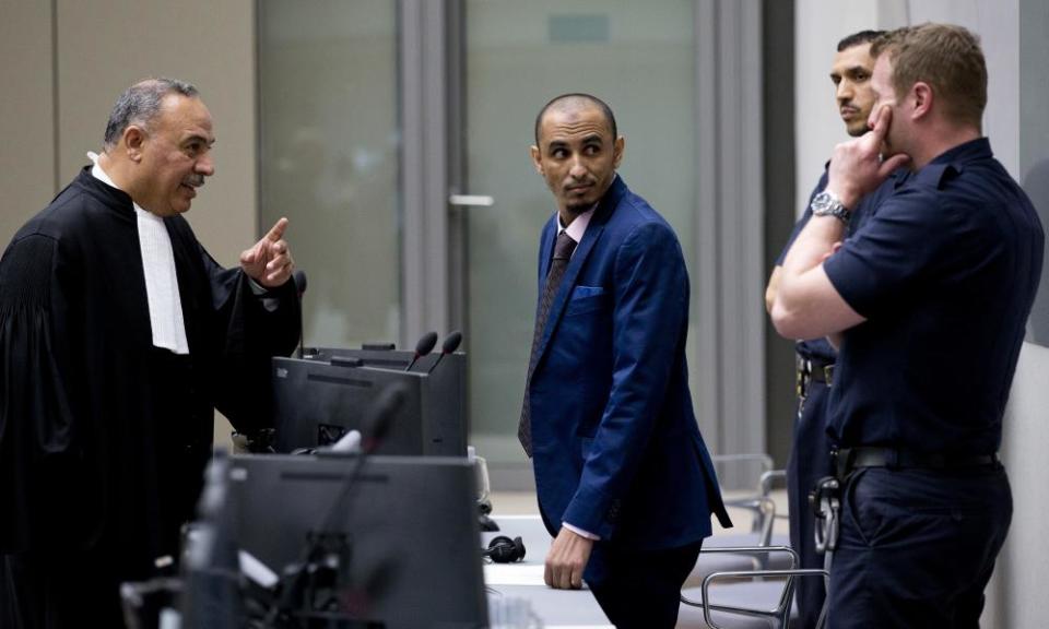 Al Hassan Ag Abdoul Aziz Ag Mohamed Ag Mahmoud (centre) listens as his counsel talks to security guards at the international criminal court in The Hague in April 2018.