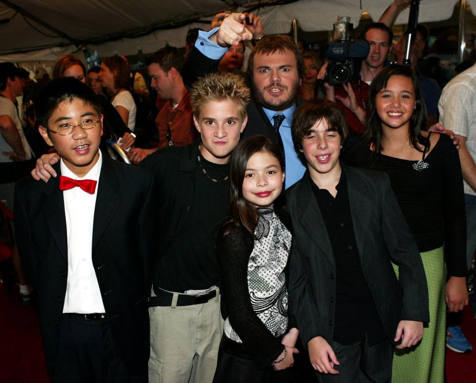 Jack Black, back, with child cast members, left to right, Robert Tsei, Kevin Clark, Miranda Cosgrove, Joey Gaydos and Rebecca Brown, attend the gala screening for "School of Rock" during the 2003 Toronto International Film Festival on Sept. 10, 2003, in Toronto, Canada.