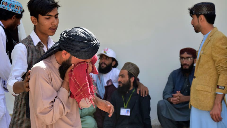 People mourn a relative who was killed in the explosion. - Arshad Butt/AP