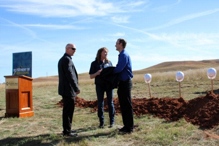From left, Pennington County Sheriff Brian Mueller, South Dakota Secretary of Corrections Kellie Wasko and Ryan Brunner, senior policy adviser and director of legislative relations for Gov. Kristi Noem, participate in a groundbreaking ceremony for a women’s prison Oct. 16, 2023, in Rapid City.