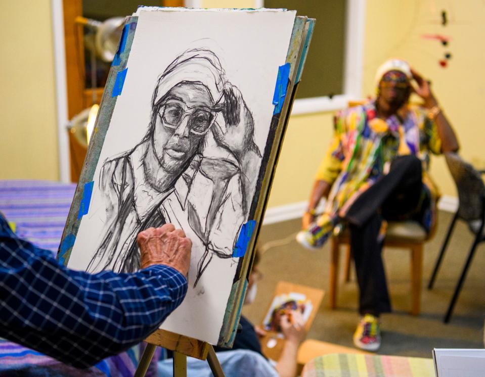 Bruce Kell works on his portrait of PDVNCH Oct. 28 during the Bloomington Portrait Group's session with the artist at The Vault at Gallery Mortgage.